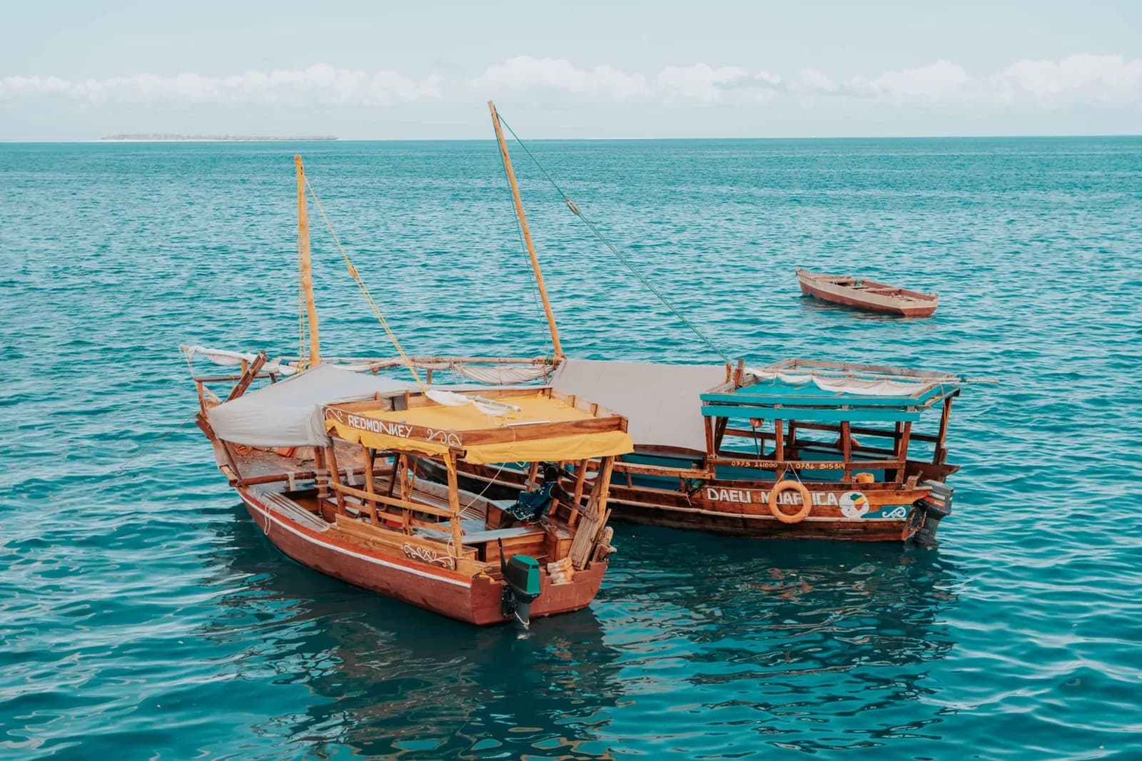 Traditional dhows moored on the water off the Zanzibar coast